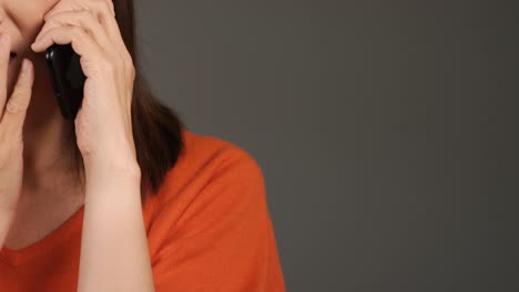 Middle-Aged-Woman-Receiving-Bad-News-On-Phone-with-Copy-Space