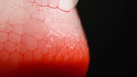 closeup of refreshing soda drink with ice cubes and bubbles in glass cup