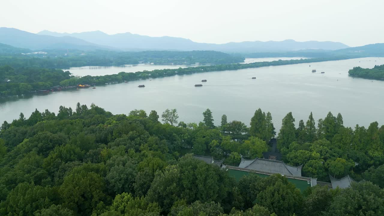 Overcast Drone View of Hangzhou&rsquo;s West Lake with Boats, Green Canopy Below