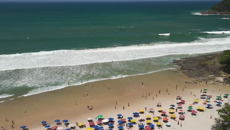 aerial view of crowded beach with colorful umbrellas