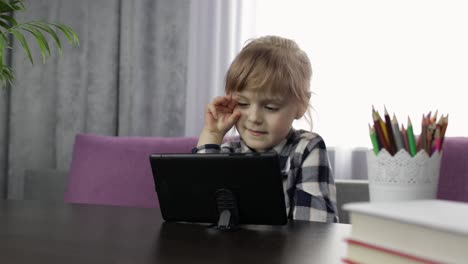 girl studying online homework using digital tablet computer. distance education