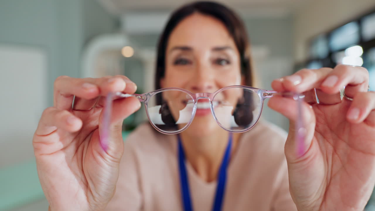 Woman holding up a pair of eyeglasses