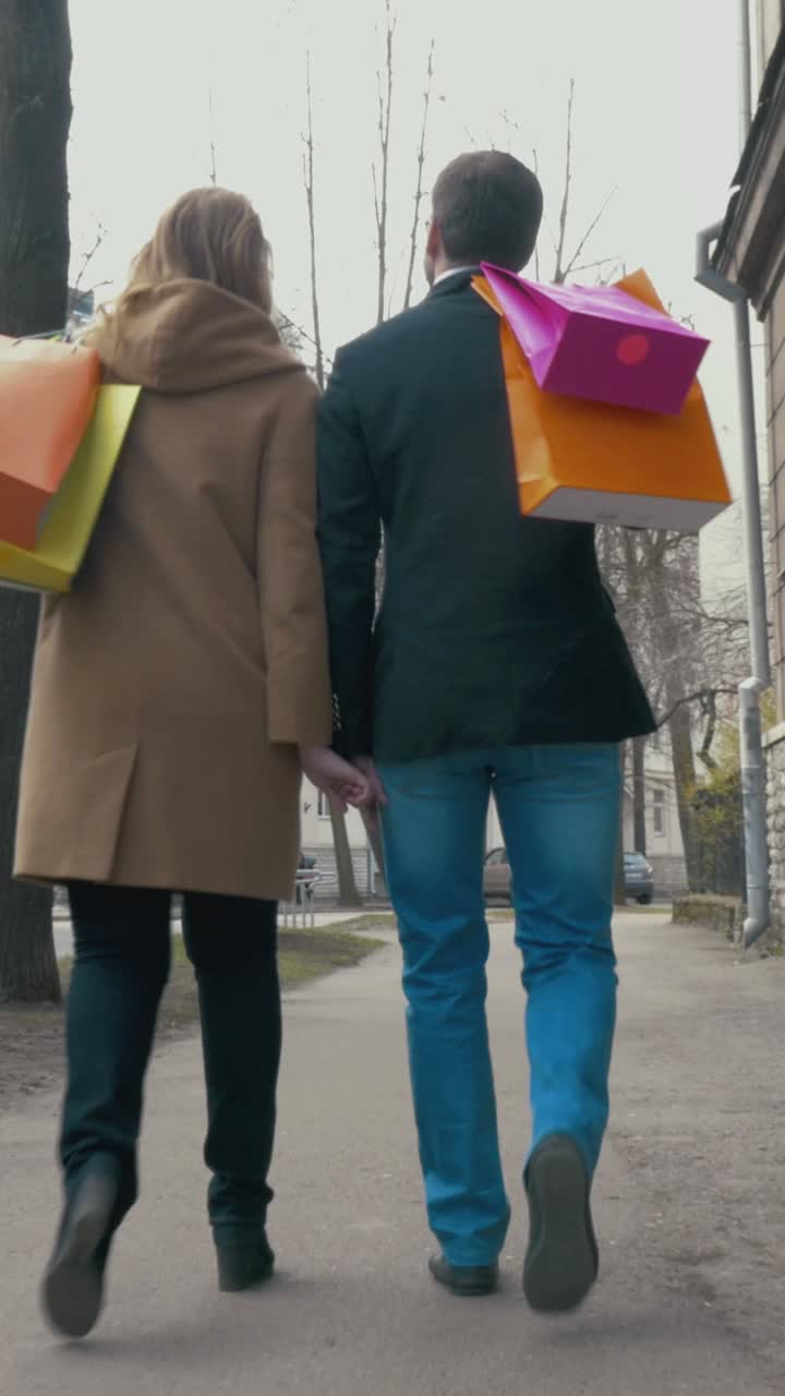 Couple walking with shopping bags