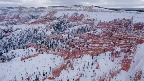 aerial 4k footage of bryce canyon national park covered in snow in utah, usa