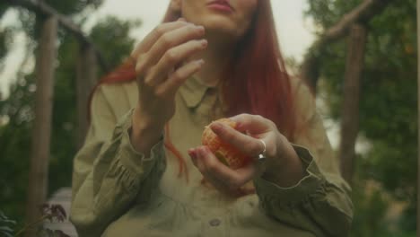woman eating oranges in a garden