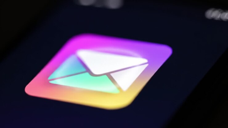 A Close-Up Look at a Colorful Messaging Icon Transitioning from a Generic Symbol to an Email Envelope Sign on a Dark Smartphone Screen