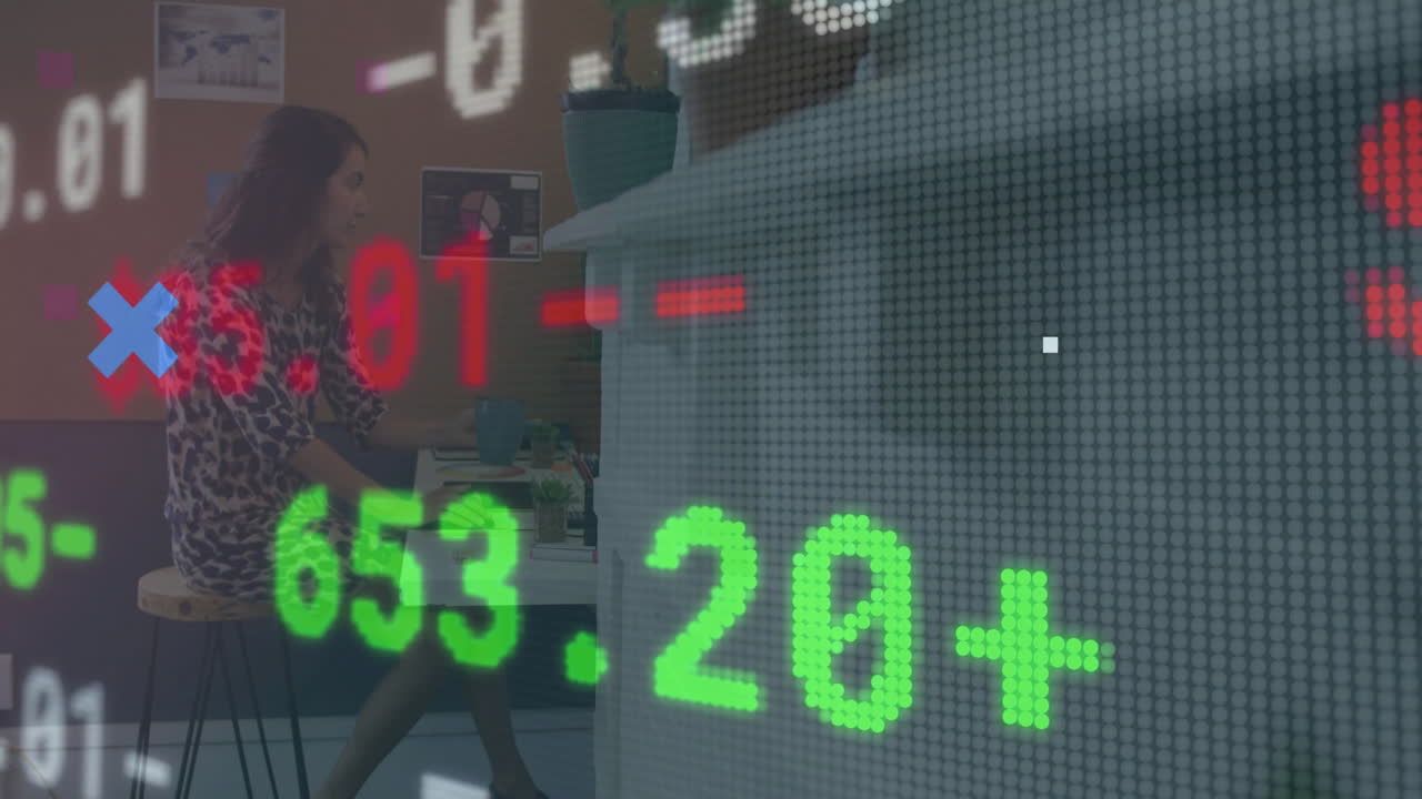 Stock market data animation over person working at desk in office