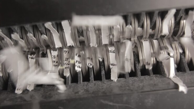 Shredder Cutting Paper From Below, Two Sheets, Pan Left To Right
