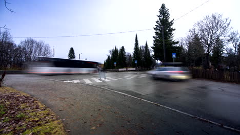 traffic on wet asphalt street at sunset in tromso, norway. timelapse