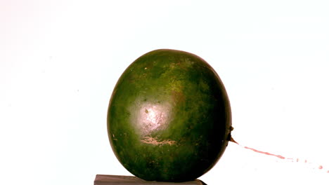 Arrow-shooting-through-watermelon-on-white-background