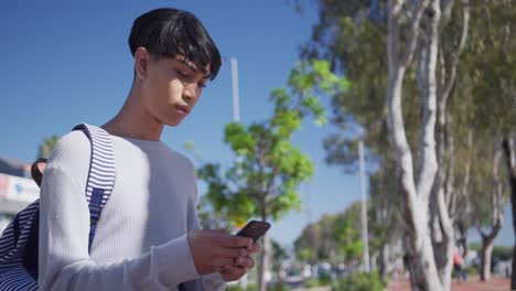 transgender adult using a phone in the street