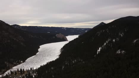 A-Breathtaking-View-of-Paul-Lake-Dressed-in-a-Blanket-of-Glistening-Snow,-Set-Against-a-Backdrop-of-Lush-Evergreen-Forests-in-Kamloops,-British-Columbia