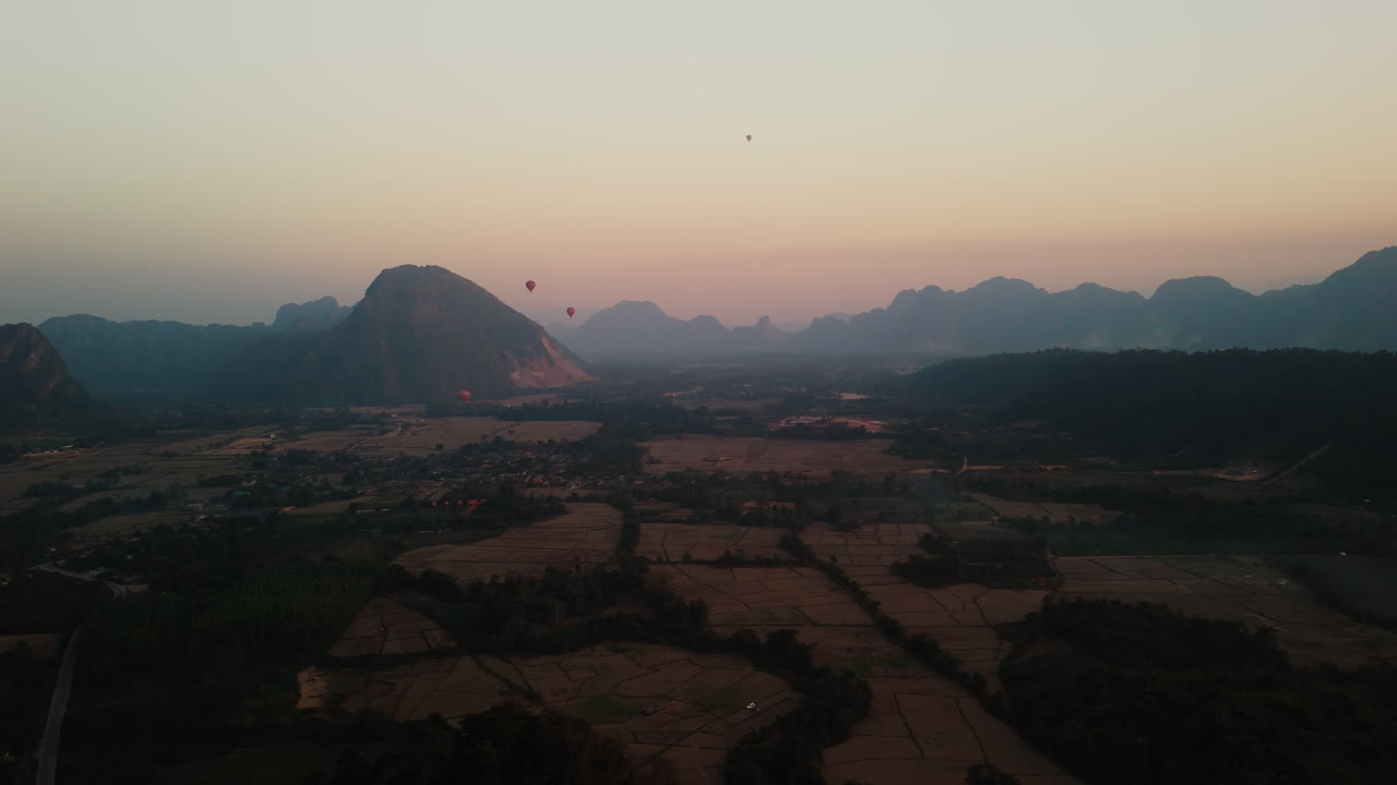 Giro in mongolfiera all'alba su una valle di montagna