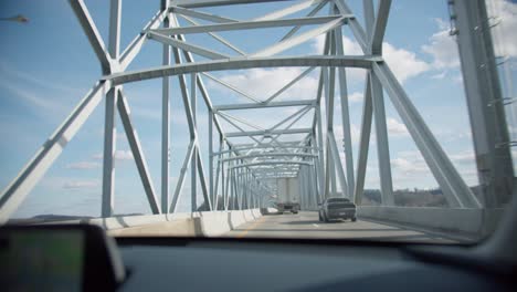 driving over a bridge on the highway pov beautiful cloudy day (slow motion)