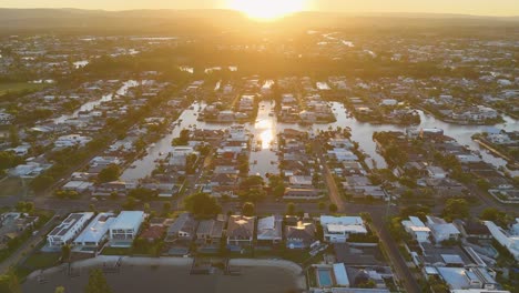 drone captures gold coast's nerang river at sunset, showcasing vibrant cityscape and waterways with dynamic lighting and movement