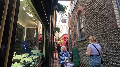 people walking through a narrow alleyway