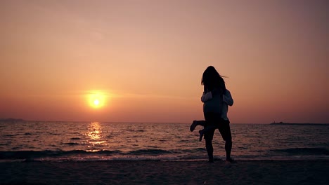 girl runs to guy and couple turns on beach slow motion