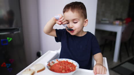 toddler eating tomato soup