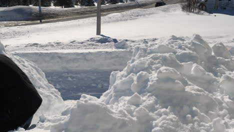 snow being thrown on snow pile with a shovel in slow motion