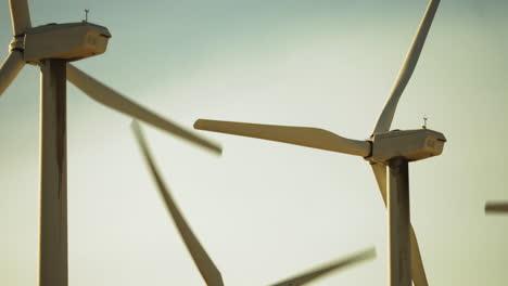 Steady-detalied-view-of-back-of-wind-turbines-with-rotors-and-blades-at-a-wind-farm-near-Palm-Springs-in-the-Mojave-Desert,-California,-USA