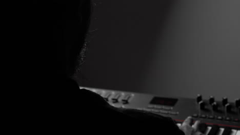 Closeup-show-of-ethnic-musician-playing-keys-on-piano