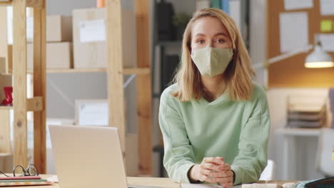 woman working from home wearing mask