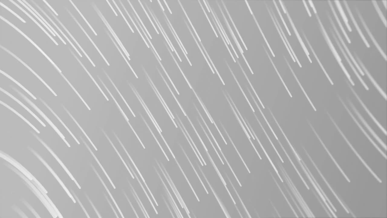 Animation of glowing light trails moving over grey background