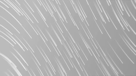 animation of glowing light trails moving over grey background