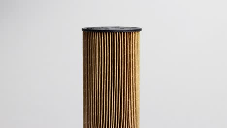 dirty spent fuel car filter on white background. concept of high quality car fuel, fuel cleaning, macro, industry