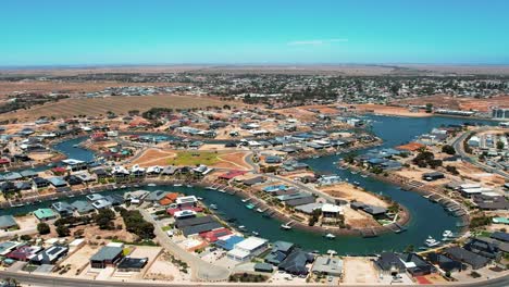 aerial orbiting view over wallaroo marina, picturesque water canal shape, australia