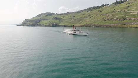 drone flying away from old cruise ship on lake geneva