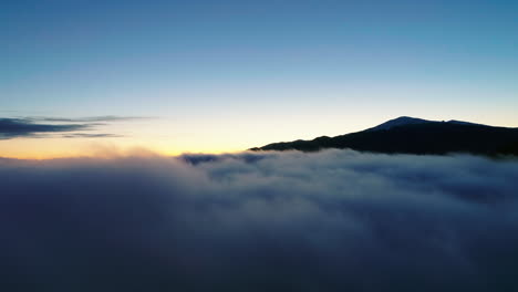 coming out of the clouds to reveal the light of dawn in the mountains