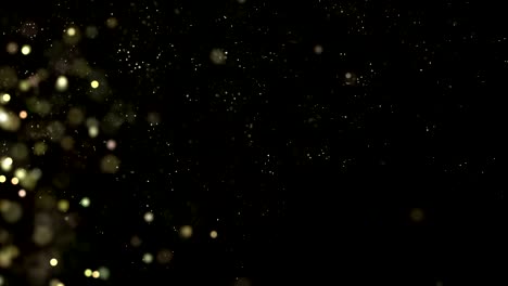 las partículas brillantes negras y doradas brillan y se desplazan a lo largo de una corriente suave. fondo de movimiento abstracto bucle sin costuras