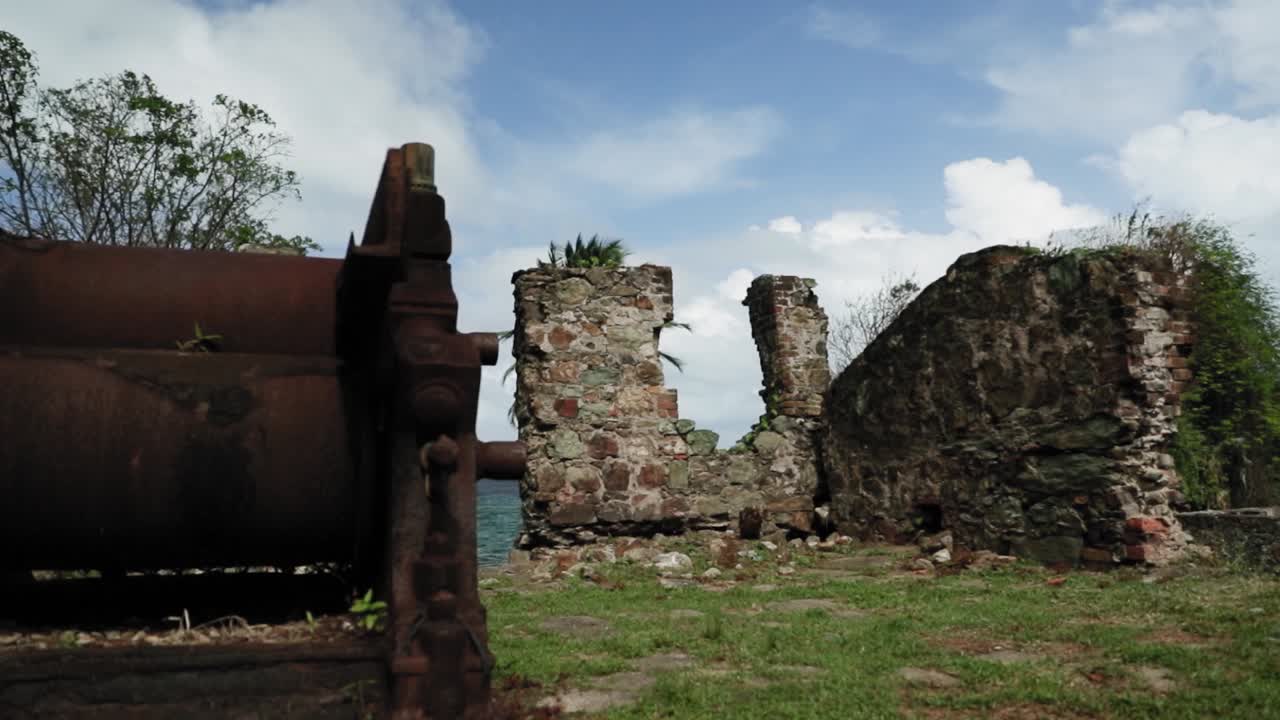 Historic abandoned factory with a giant water wheel in Tobago.