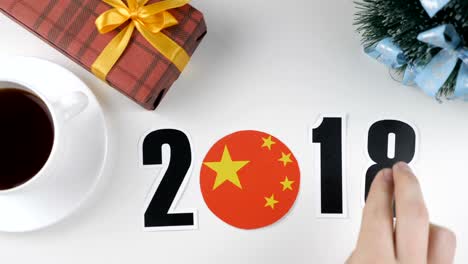 illustration, new year, male hand changes the year from 2017 to 2018, china flag, cauntry ball.