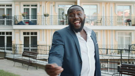 Playful-afro-business-man-dancing-outside.-Business-guy-relaxing-after-work