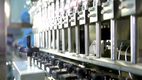 automatic mechanized production line fills glass bottles industrial technological craft beer conveyor for bottling process in a wine factory