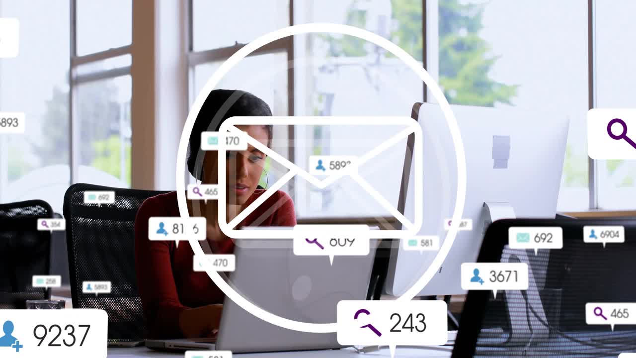 Business team typing on laptops in office, showing overlaid email icons and notification badges