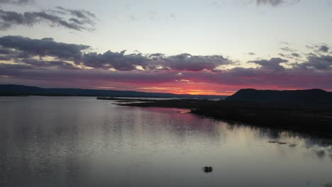 sunset over a river with dramatic clouds