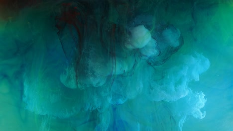 spreading of blue, green and white paint in a liquid pink space.