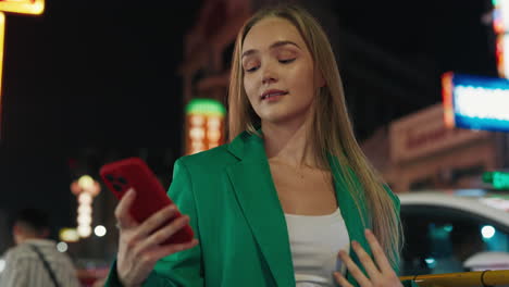 Woman Taking Selfie at Night in a City