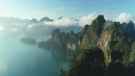 an aerial view shows green mountain islands of khao sok national park in surat thani thailand among clouds