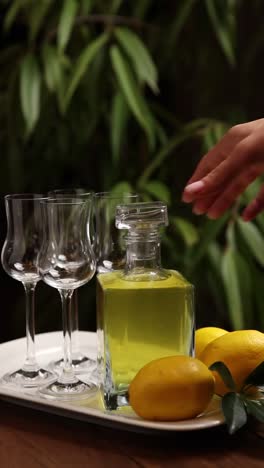 woman pouring limoncello into shot glasses