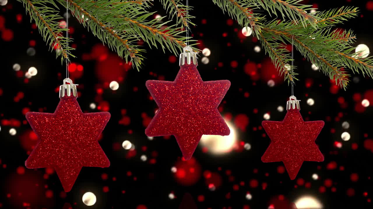 Hanging red star-shaped Christmas ornaments with festive lights in background
