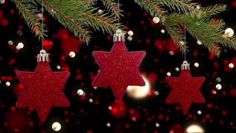 hanging red star-shaped christmas ornaments with festive lights in background