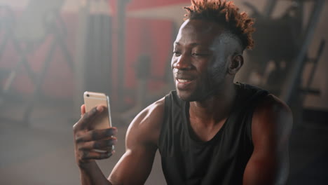 man using smartphone in gym