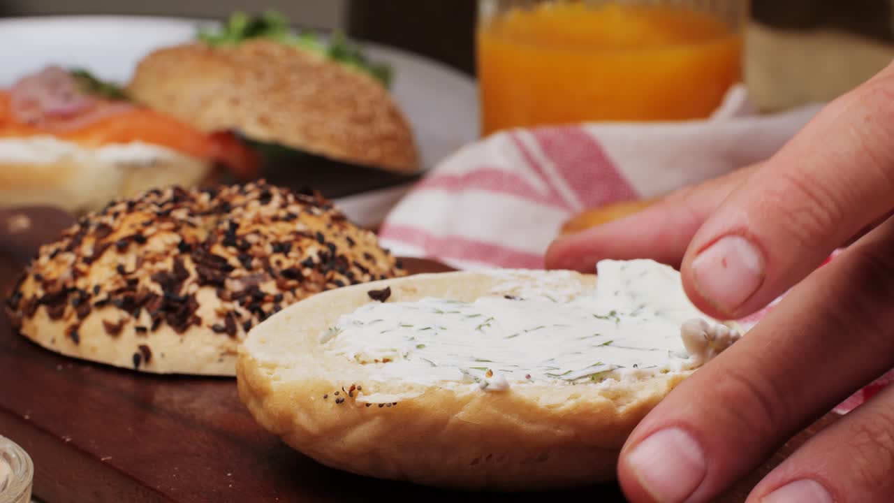 Bagel sandwich brunch, lunch plate of a bagel with smoked salmon and cream cheese and ham, close up morning cafe menu.