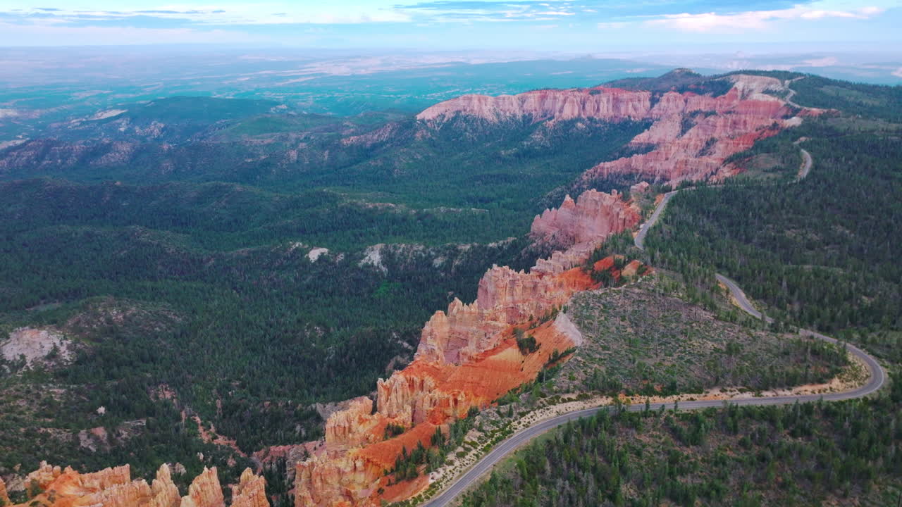 Amazing blue skies over the mountainous landscape overgrown with green pine trees. Highway going by the tops of wonderful canyons in Zion National Park, Utah, USA.