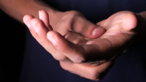 closeup of a person's hands holding the wrist