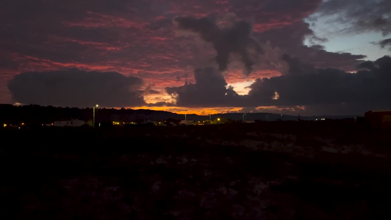 Static view of dramatic sky with wonderful clouds colored with orange. Night